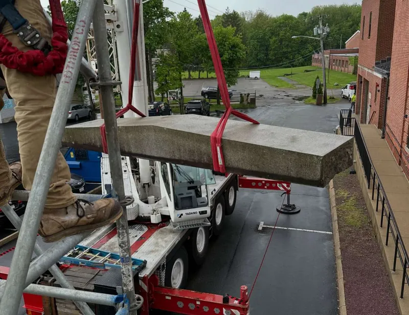 Lifting a capstone back into place by crane