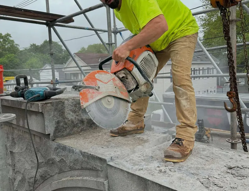 Cutting stone on the scaffold at the top of the arch
