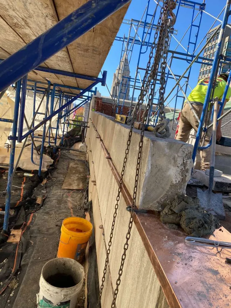 Stone coping set over new copper flashing