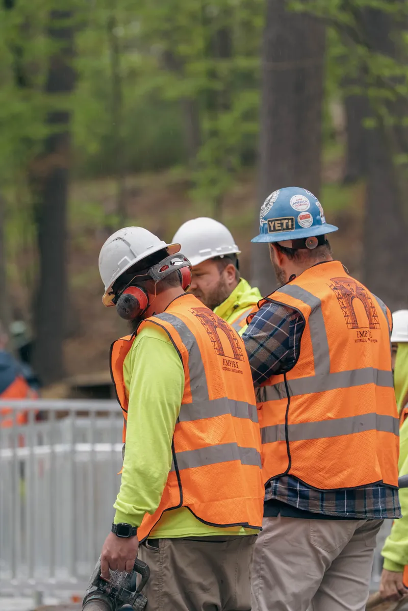 Two Empire crew members in company vests at Walden Pond