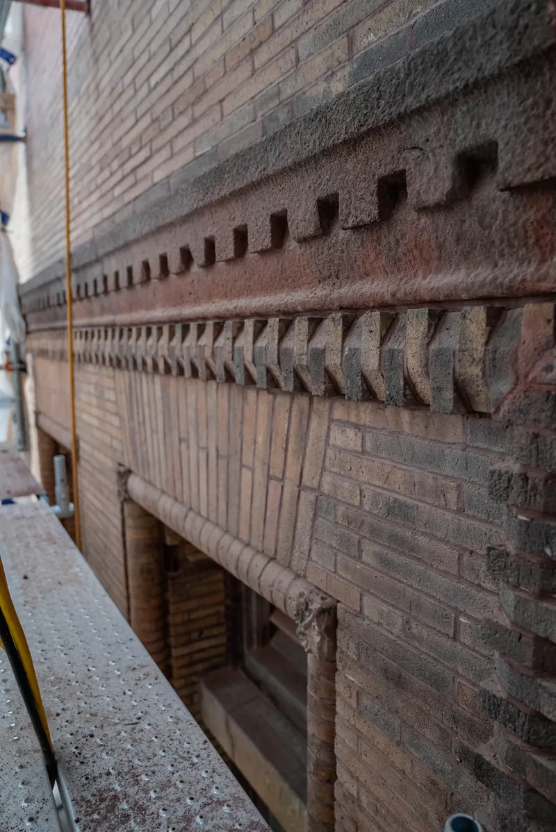 Corbelled brick and brownstone cornice from the scaffold deck