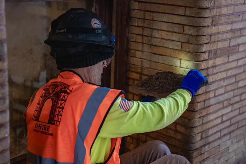 Checking finished joints at a brick pier