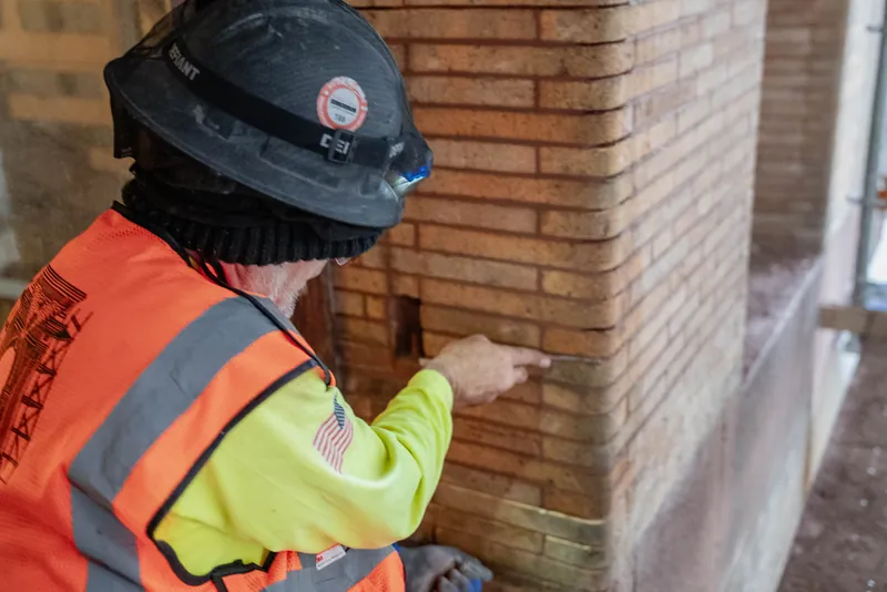 Inspecting completed joints on a brick pier
